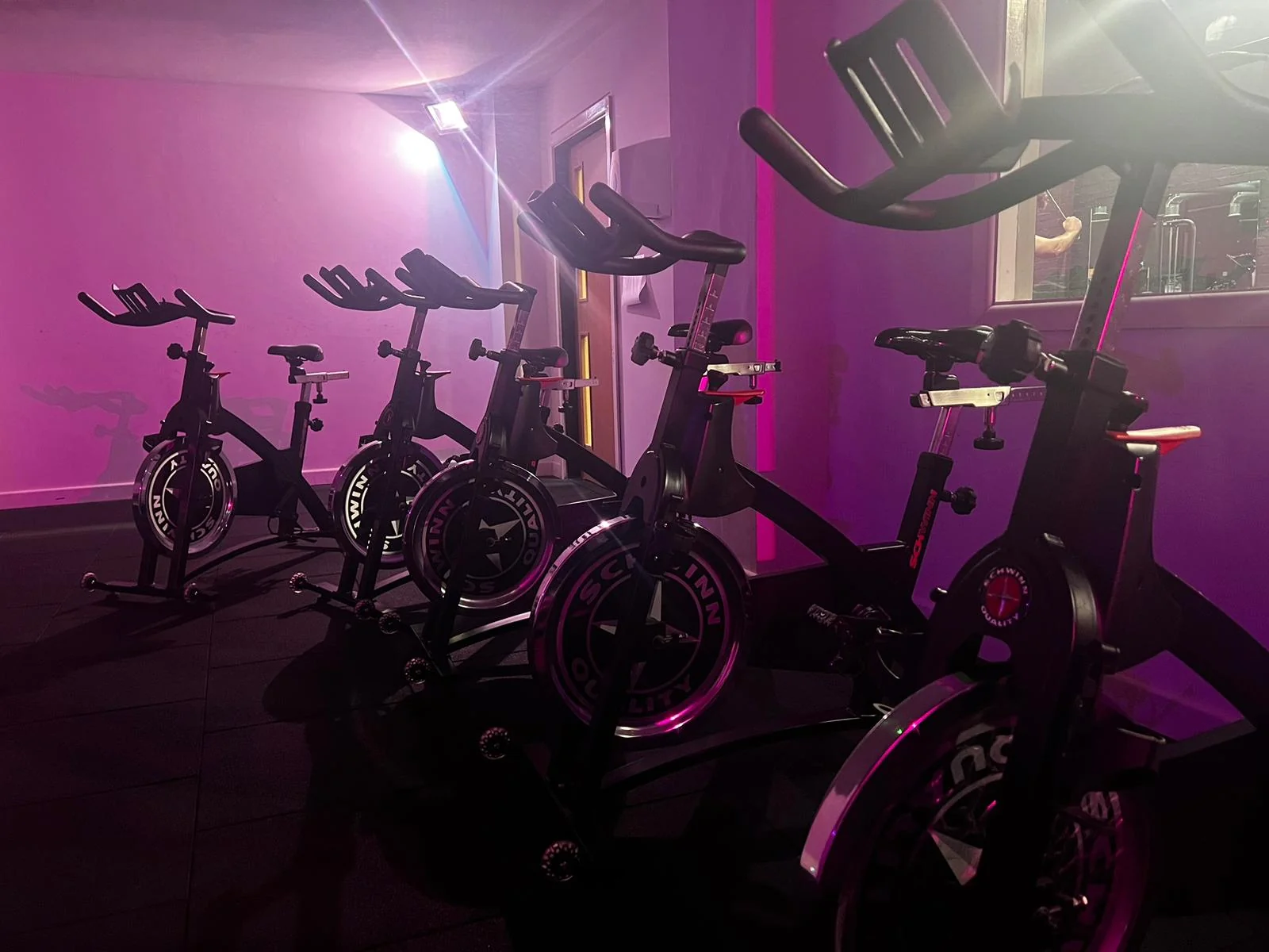 High-energy spin class with indoor cycling bikes at Unit 9 Gym Neath Wales