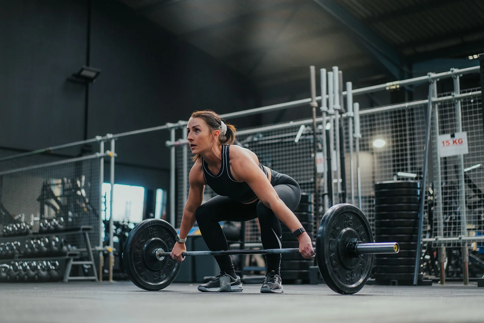 Women's strength training class with barbells and weights at Unit 9 Gym Neath Wales